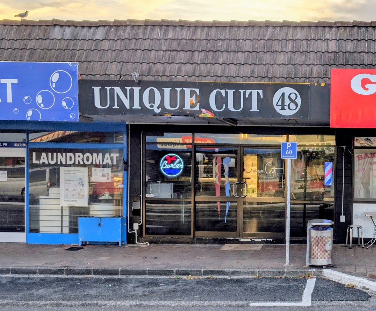 Unique Cut 48 shopfront on Great North Road with neon barber sign